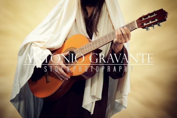Jesus Christ Plays Guitar and Man Wearing Jesus Christ Costume and Plays Guitar